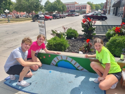 Gannan Sallach, Ashley Schmid, and Brinkly Sallach are all smiles as they work on Sallach’s art design.