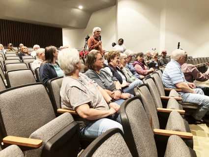 Red Oak resident Larry Brandstetter, standing, asks a question of the ISU students during the presentation.